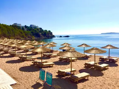 a group of umbrellas and chairs on a beach at Sea View NewApartment-Bulgaria-Chernomorets in Chernomorets