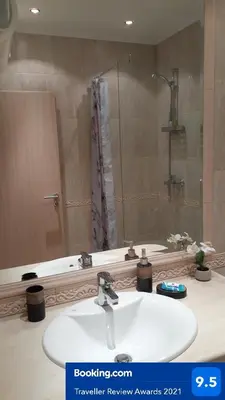 a bathroom sink with a mirror and a shower at RELAX Apartment in Varna South Bay Residence in Varna City
