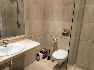 a bathroom with a toilet and a sink and a shower at RELAX Apartment in Varna South Bay Residence in Varna City