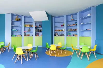 a classroom with tables and chairs and bookshelves at Alua Helios Bay - All Inclusive in Obzor
