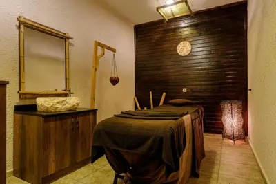 a room with a bed and a mirror and a wooden wall at Alua Helios Bay - All Inclusive in Obzor
