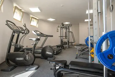 a gym with several treadmills and exercise bikes at Marine Beach Sands- All Inclusive in Obzor