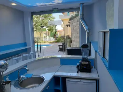 a kitchen with a sink and a counter with a camera on it at Incanto Apartments in Sveti Vlas