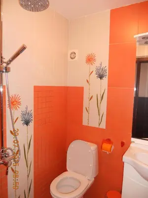 a bathroom with a toilet and flowers on the wall at Incanto Apartments in Sveti Vlas