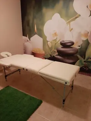 a white bench in a room with candles and a wall at Incanto Apartments in Sveti Vlas