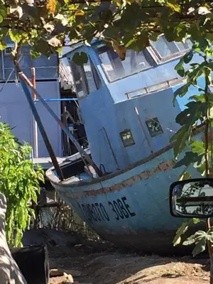 a boat sitting in front of a house at Luxury House In Chervenka next to Gradina beach in Chernomorets