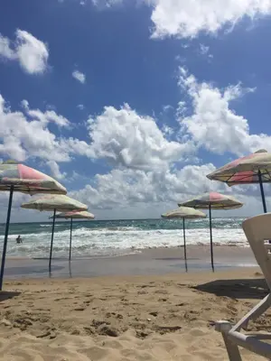 a group of umbrellas and chairs on a beach at Luxury House In Chervenka next to Gradina beach in Chernomorets