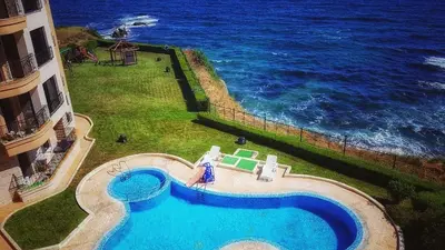 an aerial view of a swimming pool next to the ocean at VIP Sunrise Apartment in Lozenets