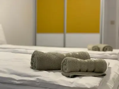 two towels sitting on top of a bed at Kati apartments in Varna City