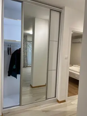 a room with mirrors and a closet with a bed at Kati apartments in Varna City