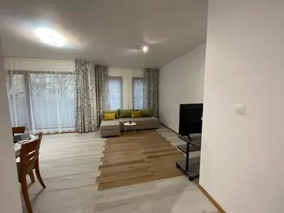 a living room with a couch and a television at Kati apartments in Varna City