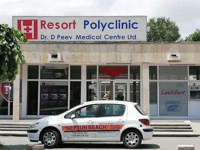 a white car parked in front of a hospital at Debbies 2 bed apart with pool and garden views in Sunny Beach