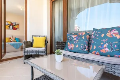 a living room with a couch and a table at Blue Lagoon Seafront Apartments in Varna City