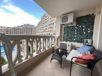 a balcony with a view of a building at Blue Lagoon Seafront Apartments in Varna City