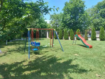 a playground with a swing set in a park at Къща за гости АКАЦИЯ in Ravna Gora