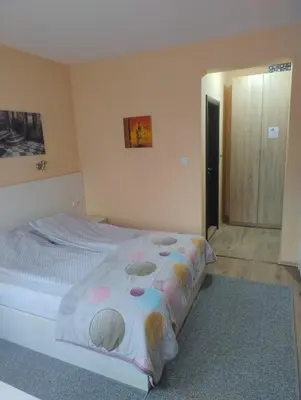 a bedroom with a bed with a blanket on it at Къща за гости АКАЦИЯ in Ravna Gora