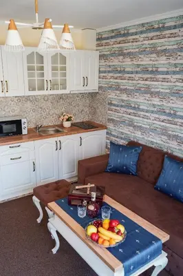a living room with a table with fruit on it at Sunny Apartments Obzor in Obzor