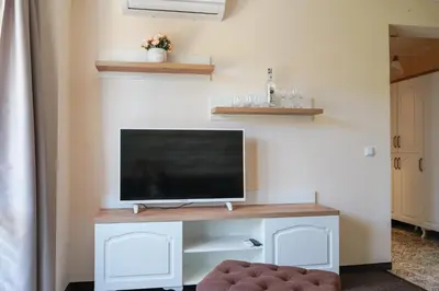 a living room with a tv on a desk at Sunny Apartments Obzor in Obzor