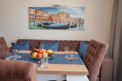 a table with a bowl of fruit and a boat at Sunny Apartments Obzor in Obzor