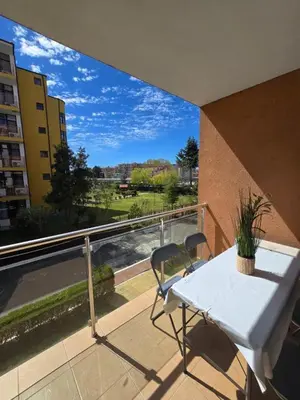 a white table and chairs on a balcony with a view at Apartment in Trakia Plaza complex in Sunny Beach