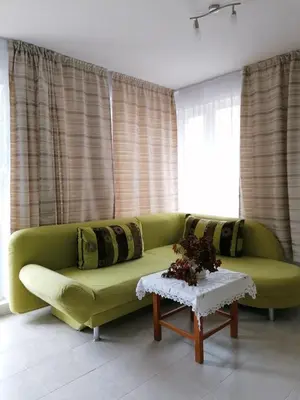 a green couch in a living room with a table at Complex Argo ap.2 in Ravda