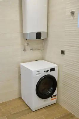 a washer and dryer in a corner of a room at Luxury Nevena Apartment - Bogoridi super centre in Burgas City
