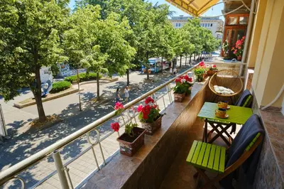 a balcony with a table and chairs and a street at Luxury Nevena Apartment - Bogoridi super centre in Burgas City