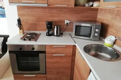 a small kitchen with a sink and a microwave at Yves 2 Bed apart at Sun Village Sunny Beach not far away from the sea in Sunny Beach