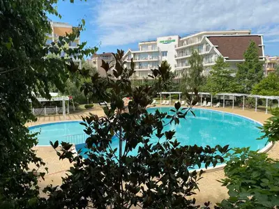 a large blue swimming pool in front of a building at Yves 2 Bed apart at Sun Village Sunny Beach not far away from the sea in Sunny Beach