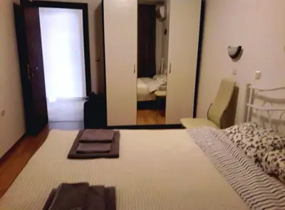 a bedroom with a bed with a mirror and a room with a bed sidx sidx at Mare Nero in Sozopol