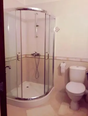 a bathroom with a glass shower and a toilet at Mare Nero in Sozopol