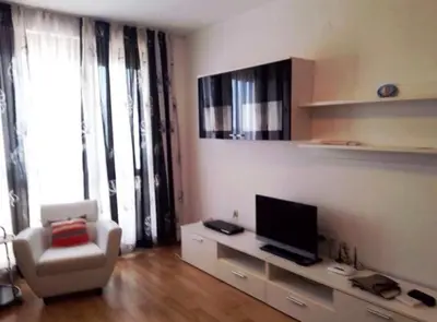 a living room with a tv and a chair and a couch at Mare Nero in Sozopol