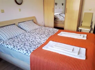a bedroom with a large bed with two towels on it at Mare Nero in Sozopol