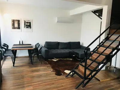 a living room with a couch and a table at Вила ОмниЯ in Chernomorets