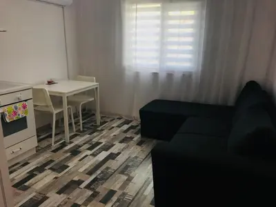 a living room with a couch and a table at Вила ОмниЯ in Chernomorets