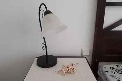 a table with a lamp and two starfish on it at Studio at 