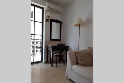 a living room with a couch and a table at Studio at 
