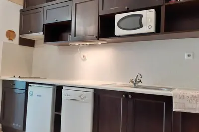 a kitchen with a sink and a microwave at Studio at 