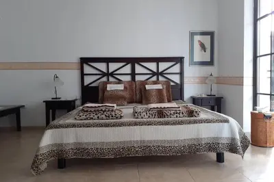 a bedroom with a large bed and two windows at Studio at 