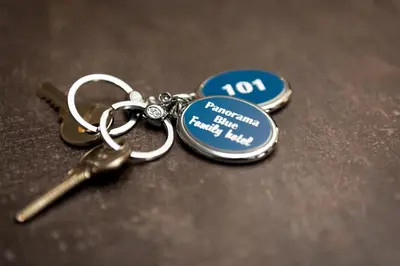 a pair of keys sitting on top of a table at Panorama Blue Family Hotel and Free parking in Nesebar