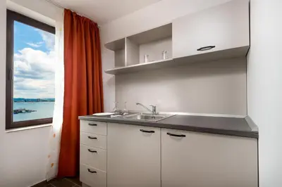 a kitchen with a sink and a window at Panorama Blue Family Hotel and Free parking in Nesebar