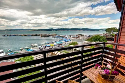 a balcony with a view of the water and boats at Panorama Blue Family Hotel and Free parking in Nesebar