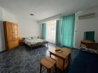 a room with a bed and a table and a couch at Студио Одеса 22 in Sozopol