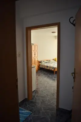 a room with a bedroom with a bed and a doorway at Студио Одеса 22 in Sozopol