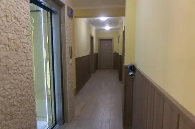 a hallway with a hallway leading to a door at Rent Apartments Martin Beach in Pomorie