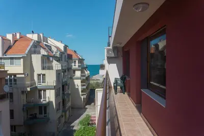 a balcony of a building with a view of the ocean at Rent Apartments Martin Beach in Pomorie