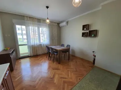 a dining room with a wooden table and chairs at Danny apartment in Burgas City