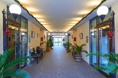 a hallway of a building with plants and tables at Private Apartments by the sea with a large terrace in Apart hotel! in Pomorie