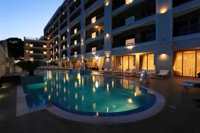 a large swimming pool in front of a building at Private Apartments by the sea with a large terrace in Apart hotel! in Pomorie