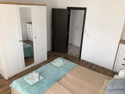 a bedroom with a bed with two towels on it at Sunny Shore Burgas Apartment in Burgas City